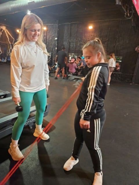 girl works out with stretch band at the Junkyard