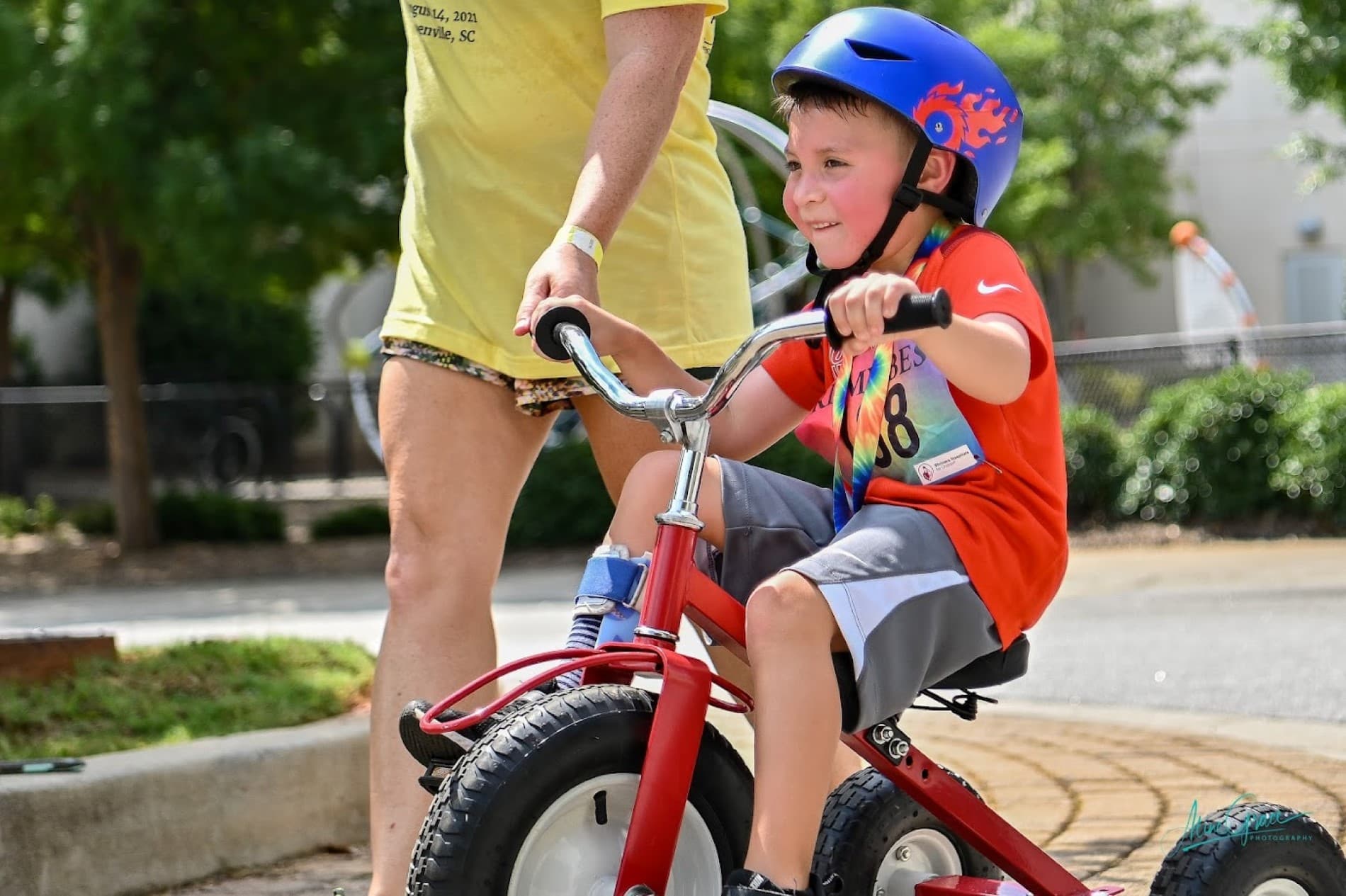 tri my best biker in blue helmet rides red tricycle