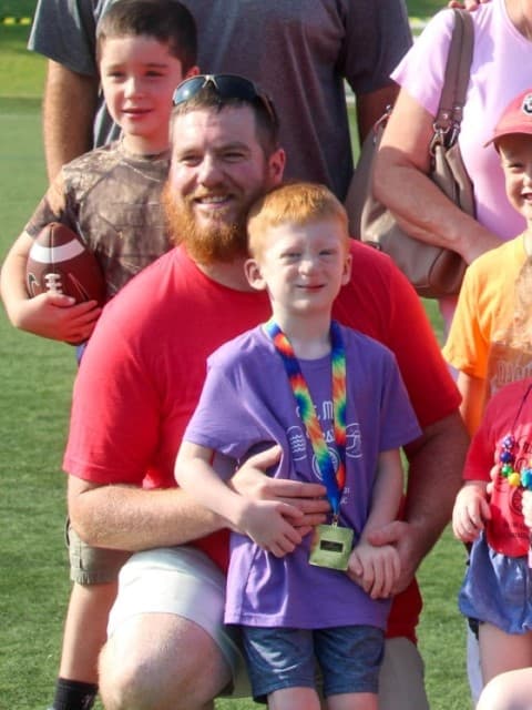 tri my best participant Grant poses with family after the race