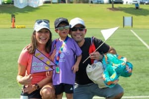 tri my best participant poses with mom and dad