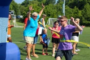 tri my best runner breaks yellow finishline tape