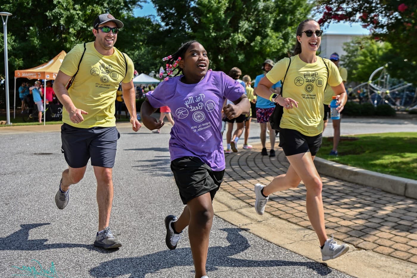 tri my best participant smiling, runs with her two buddies