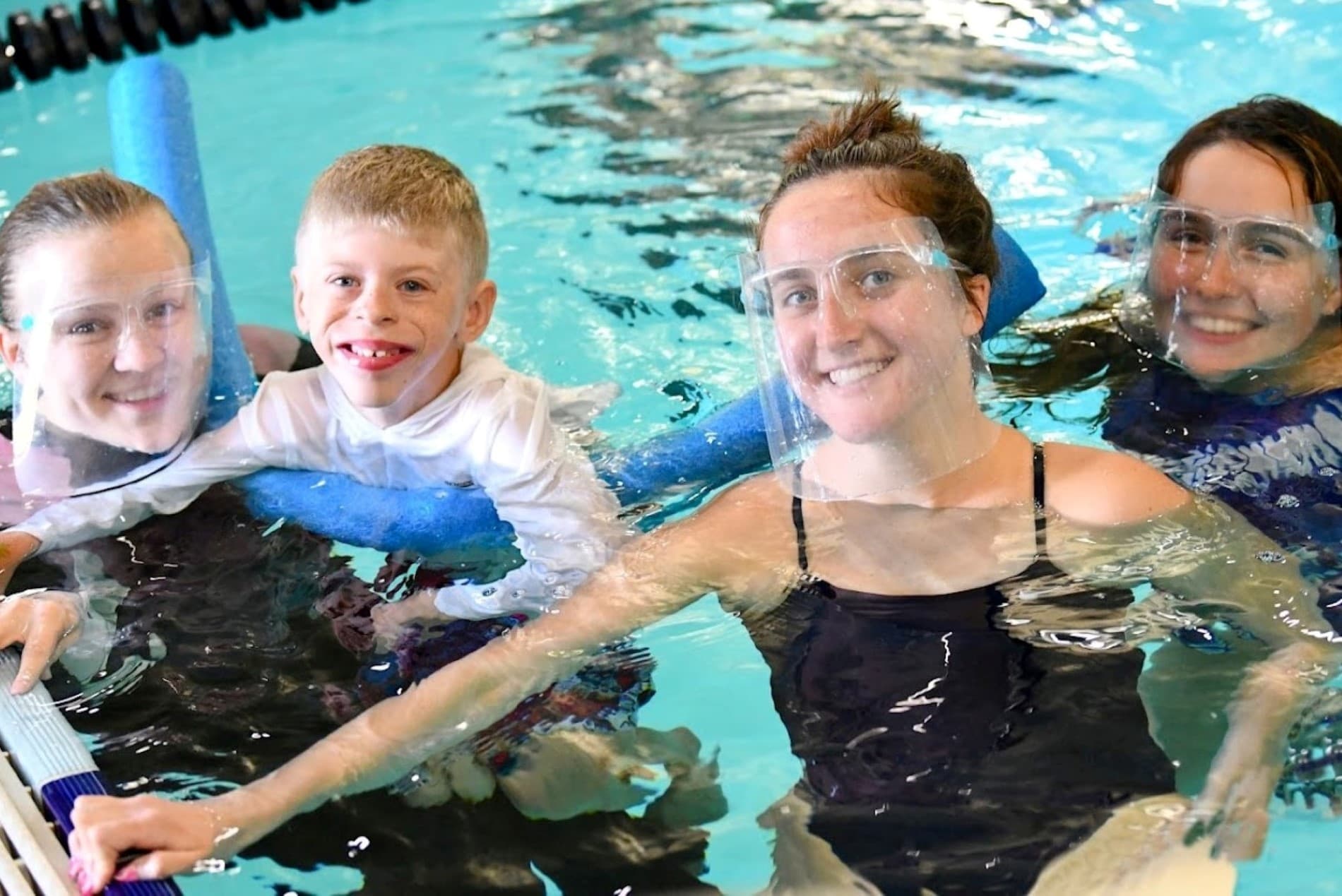 tri my best swimmer surrounded by swimming buddy volunteers