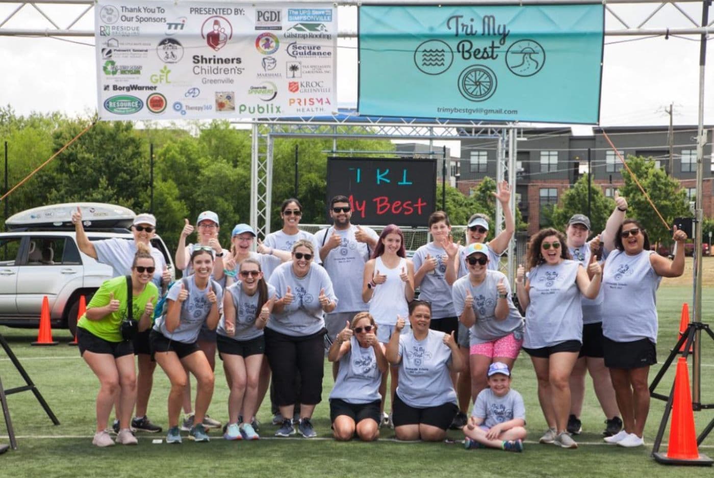 tri my best volunteers pose at finishline